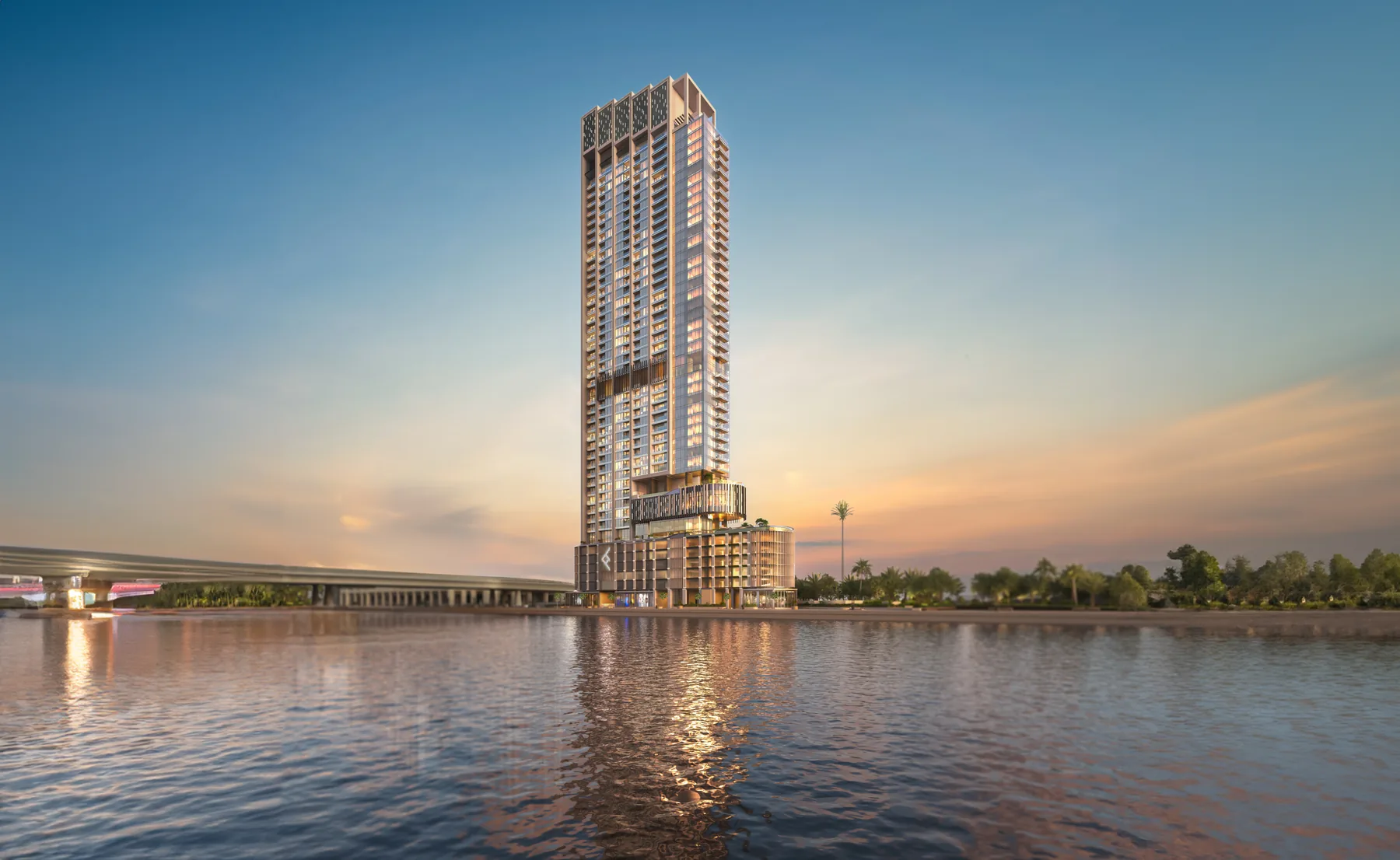 One River Point tower beside the Dubai Water Canal in Business Bay at sunset